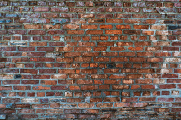 Texture of old brick wall with red cracked brick
