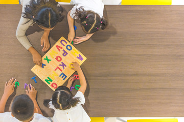 Kids and teacher playing on table