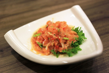 Spicy salmon sashimi salad thai fusion food style.