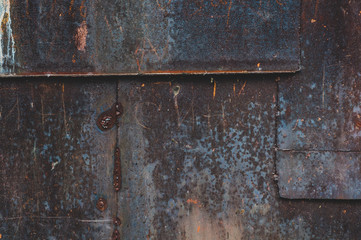 Rusty metal sheets bonded with shabby old paint