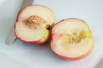 Fresh white nectarine cut in half
