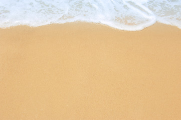 Fototapeta na wymiar Soft ocean wave on clean sandy beach
