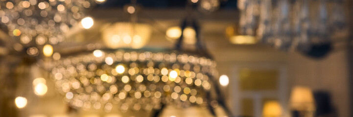 Golden luxury blurred background of bokeh chandeliers - obrazy, fototapety, plakaty