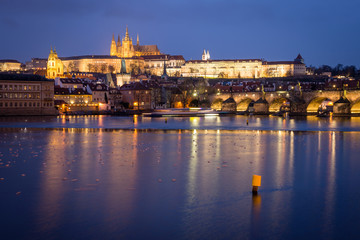 Fototapeta na wymiar Prague Castle and Charles Bridge at sunset with reflection on Vltava river, Czech republic