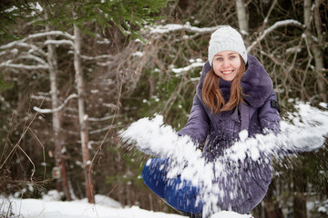 Girl in a pine forest on a winter day