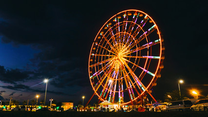 Time lapse ferris wheel on a sunset background on the sea