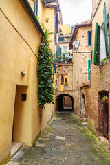 Medieval narrow street in Siena, Tuscany, Italy.