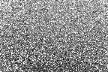 Abstract black shimmer and shiny glitter background with bumpy textured