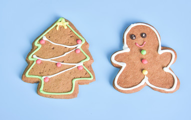 Gingerbread with Christmas tree isolated on light blue pastel background