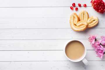Valentine's day Breakfast concept. Cup of coffee and a cookies hearts on a white table. copy space, flat lay.