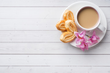 Valentine's day Breakfast concept. Cup of coffee and a cookies hearts on a white table. copy space, flat lay.