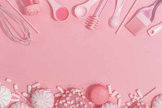 Kitchenware and tools, pastry and sweets on a pink background. Top view. Copy space.