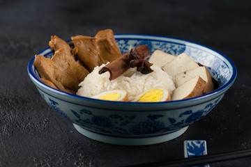 chinese braised chicken over rice with boiled egg and tofu
