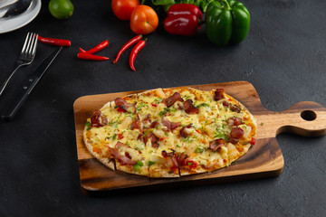 Pizza with bacon, pepperoni, melted cheese