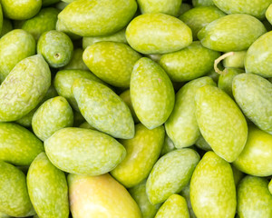 uncooked raw olives closeup, natural green background