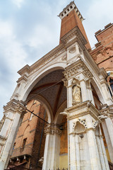 Fototapeta na wymiar Cappella di Piazza and Torre del Mangia on Piazza del Campo, square and historic center in Siena. Italy