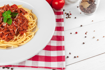Pasta with meat, tomato sauce and vegetables on the table