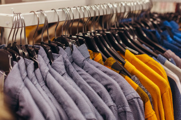 Warm top men's wear hangs on a hanger. Sale of clothes in shop