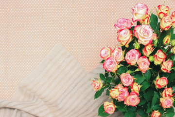Bouquet of beautiful, delicate pink roses on beige fabric background with space for text .Top view. Floral background.