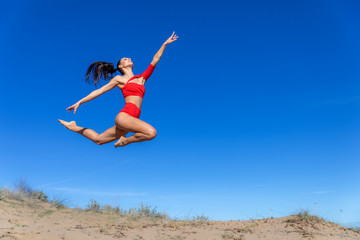 young slim beautiful woman on sunset beach, playful, dancing, running, bohemian outfit, indie style, summer vacation, sunny, having fun, positive mood, romantic, splashing water, silhouette, happy