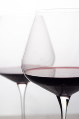 two glass glasses with red wine close up.