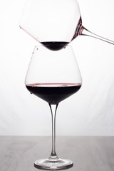 two glasses with red wine on a white background.