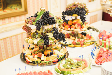 Delicious and tasty dessert table with cupcakes shots at reception closeup