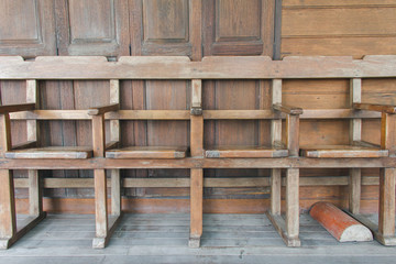 Wooden chairs are arranged in rows.