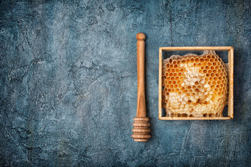 Natural product honeycomb as organic ingredient for healthy nutrition with wooden honey stick