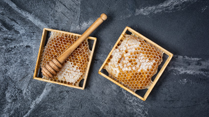 Natural product honeycomb as organic ingredient for healthy nutrition with wooden honey stick