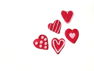 Variety of red hearts pattern handmade from plasticine clay placed on white background,  beautiful shape are doug