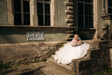 Fantastic bride walk near the palace. Wedding dress