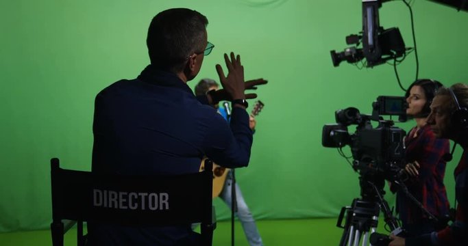 Medium shot of a young male guitar player failing at an audition