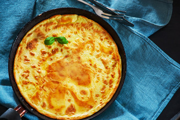 eggs omelette in a frying pan on wooden table