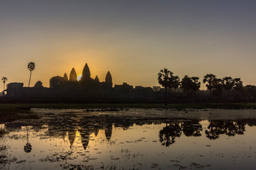 Fototapeta na wymiar Sunrise view of ancient temple complex Angkor Wat and lake reflection, Siem Reap, Cambodia.