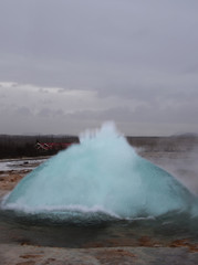 The eruption of the Strokkur geyser in the southwestern part of Iceland in a geothermal area near the river Hvitau