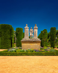 Statue of Christian kings Ferdinand and Isabella and Christopher Columbus in Alcazar de los Reyes...