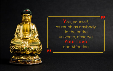 Meditating Golden Buddha statue on black background