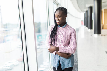 Young african woman indoor at modern business center. People lifestyle concept.