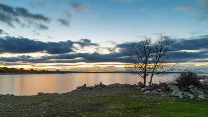 Calm lake at sunset in march