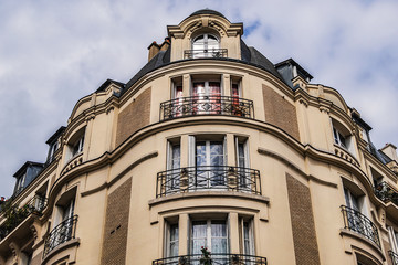 Old French house with traditional balconies and windows. Paris, France.