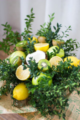 Bouquet of lemons, green apples, coconut, kiwi and boxwood