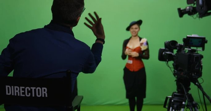 Slow motion shot of a director talking to actor and actress before they perform a scene