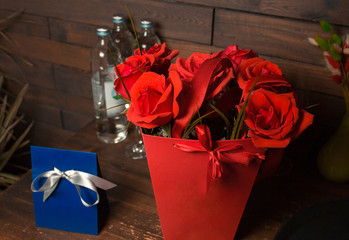 Valentine's Day concept. Man gives Romantic red roses in a square black gift box bouquet of flowers roses gift  girl in love - Image. Happy birthday ceremony presents
