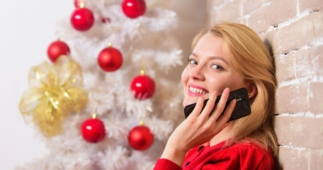 Christmas wishes concept. Woman pretty peaceful dreamy face hold smartphone enjoy mobile phone...