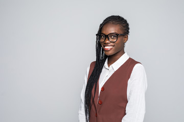 Young african woman with glasses isolated on grey background
