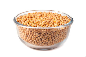 Seeds of peas on glass bowl on white background