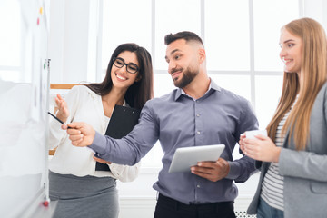 Confident colleagues discussing new project in office