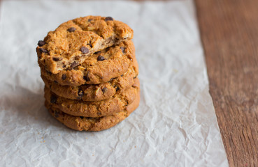 delicious crispy oatmeal cookies with chocolate chips on parchment