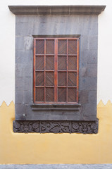 old window with shutters and two-colored wall